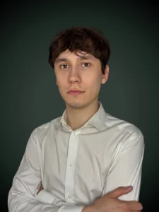 Mateusz Majos konsultant w białej koszuli na ciemnym tle
